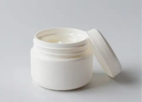 Empty White Plastic Jar with Cream on Plain Background