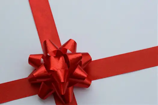 Red Ribbon with Large Bow Close-Up vibrant tightly wound gift