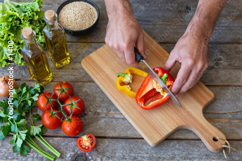 Person Cutting Bell Pepper on Wooden Board ingredients