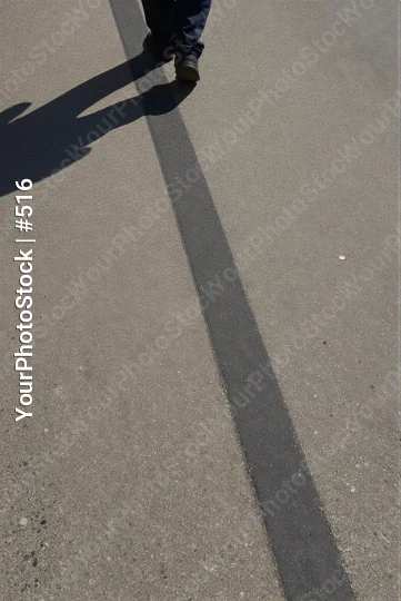 Person Walking on Concrete with Long Shadow outdoor