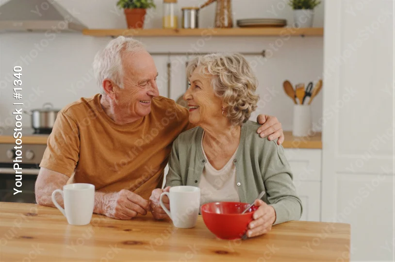 Elderly Couple Enjoying Coffee at Kitchen Table man and woman old
