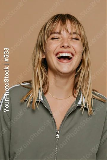 Young Woman Laughing Portrait blonde hair green jacket