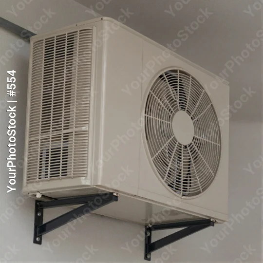 White Air Conditioning Unit with Grid Fan Mounted on Wall Bracket