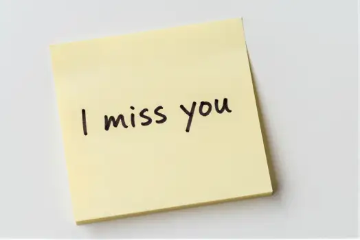 Yellow sticky note with 'I miss you' cursive text