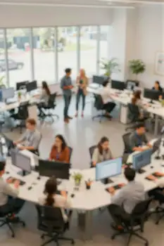 Blurred Modern Open-Plan Office with People Working desks