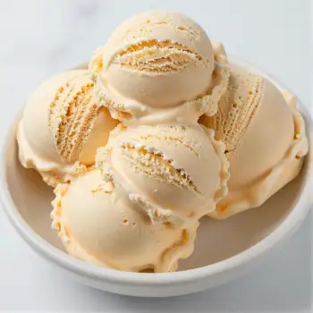 Vanilla Ice Cream Scoops in Bowl with Orange Zest
