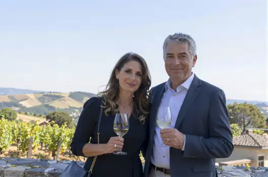 Man and Woman Smiling at Vineyard Overlooking