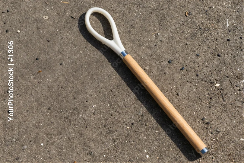 Wooden Handle with Plastic Attachment on Concrete