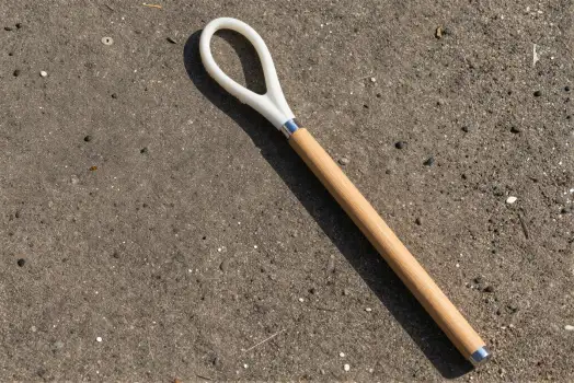 Wooden Handle with Plastic Attachment on Concrete