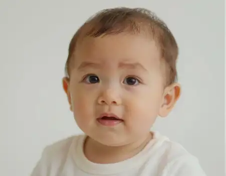 Curious Baby Portrait child face t-shirt light brown hair