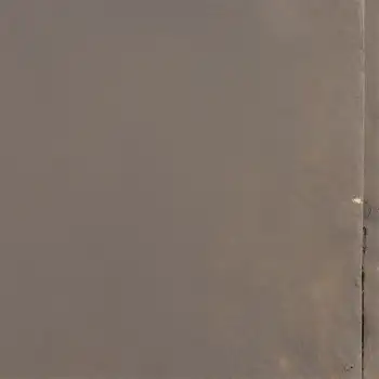 Close-up of Frayed concrete Plate with Small Hole
