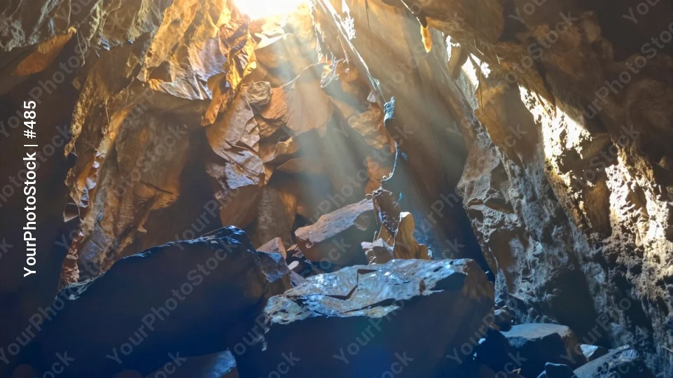 Cave Interior with Sunlight rock boulder stalactite