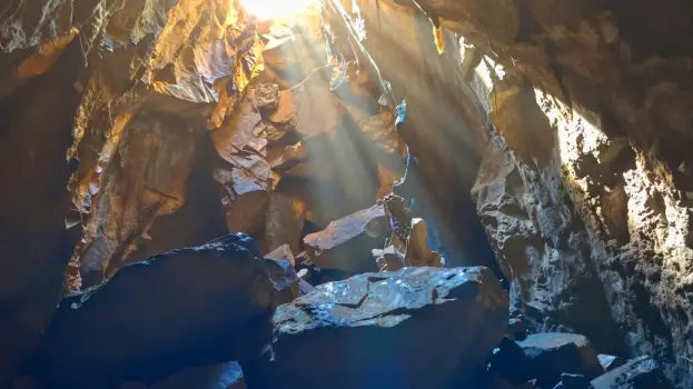Cave Interior with Sunlight rock boulder stalactite