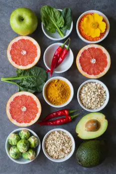 Circular Arrangement of Fruits, Vegetables, and Oats on Dark