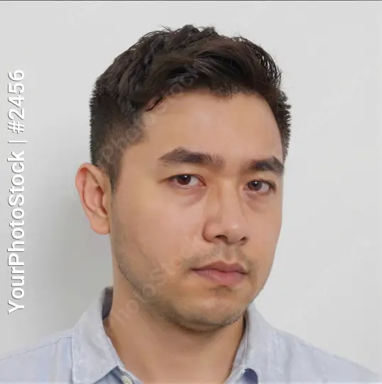 Young Man with Serious Expression in White Background