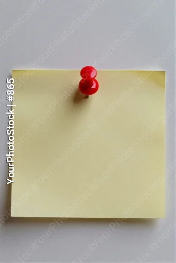 Blank Yellow Sticky Note with Red Pin on White Wall