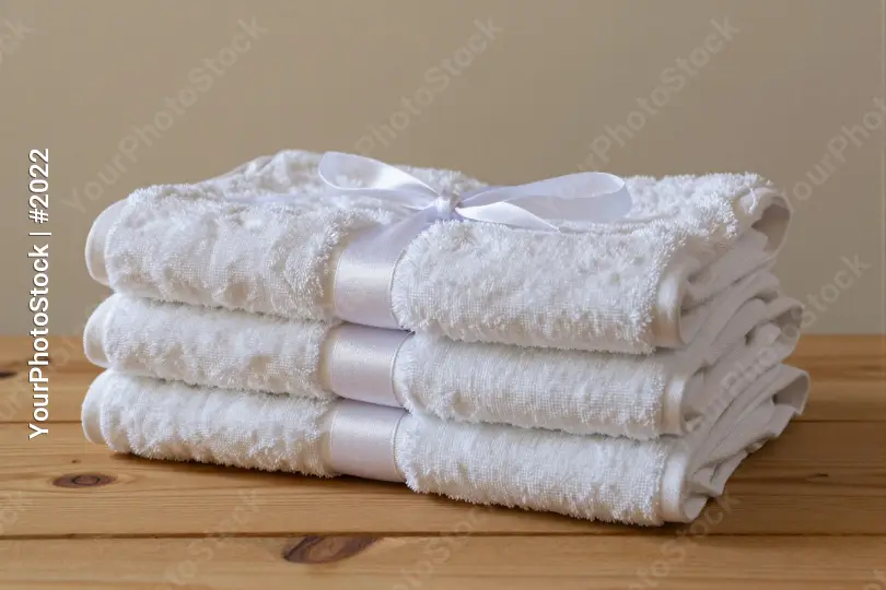 Neatly Folded White Towels Tied with Bow Ribbon hotel