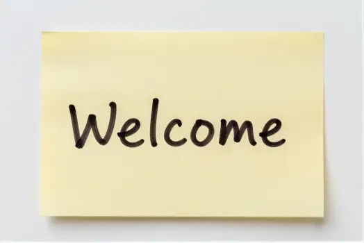 Welcome Note Hanging On White Wall sticky note
