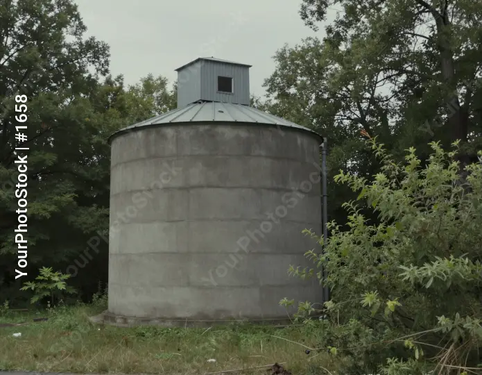 Gloomy Silo in Grassland concrete overcast trees