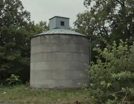 Gloomy Silo in Grassland concrete overcast trees