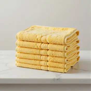Stacked Yellow Towels on Marble Countertop textured fabric hotel