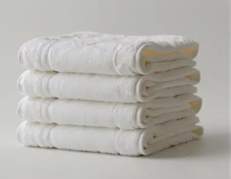 Neatly Folded White Towels with Textured Pattern hotel