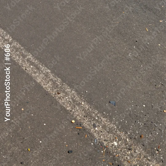 Straight white line on asphalt road with debris