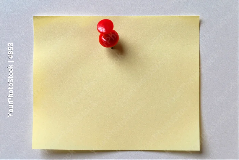 Yellow Sticky Note with Red Push Pins on White Wall