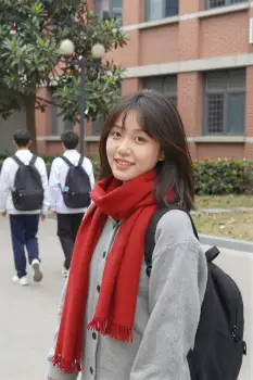 Young Asian Woman Smiling on Sidewalk brick building