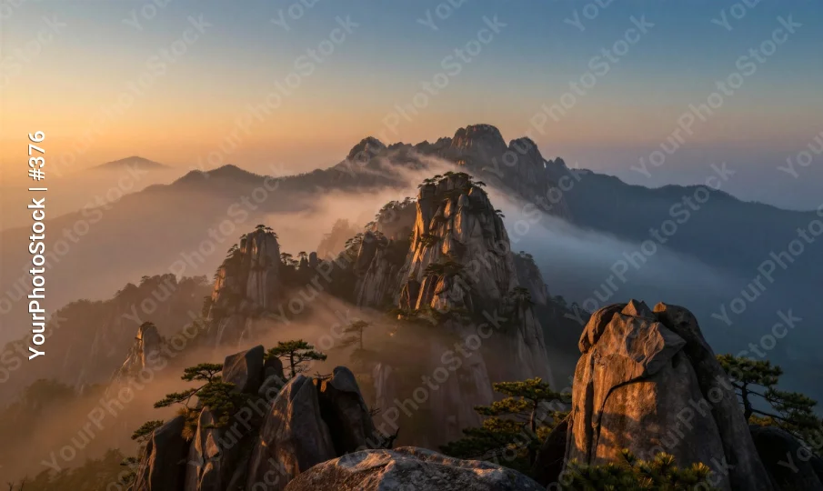 Mountain Range at Sunrise with Foggy Peaks sunset