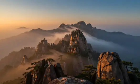 Mountain Range at Sunrise with Foggy Peaks sunset