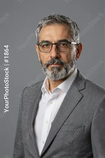 Middle-aged businessman in grey suit with serious expression
