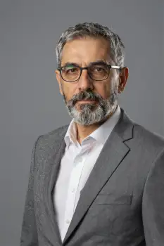 Middle-aged businessman in grey suit with serious expression