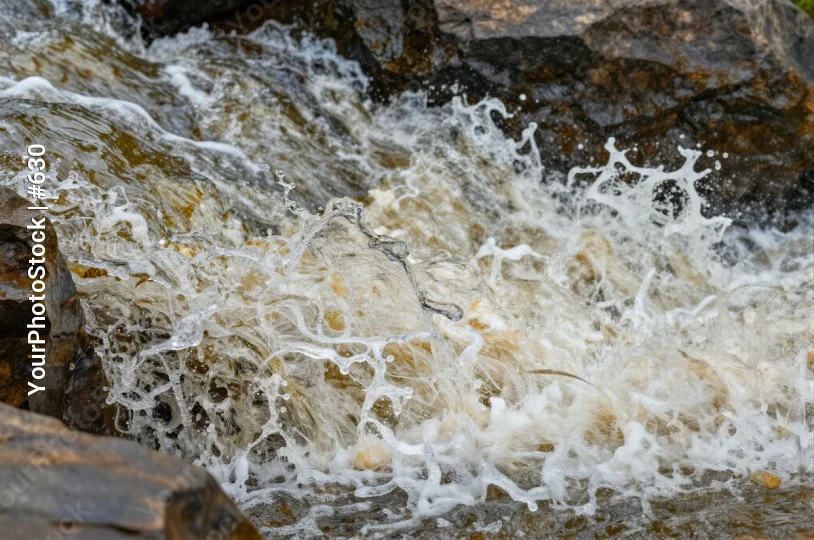 Waterfall cascading down rocky cliff cascade natural landscape