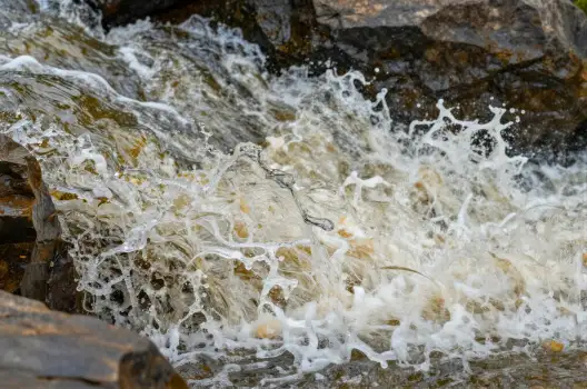 Waterfall cascading down rocky cliff cascade natural landscape