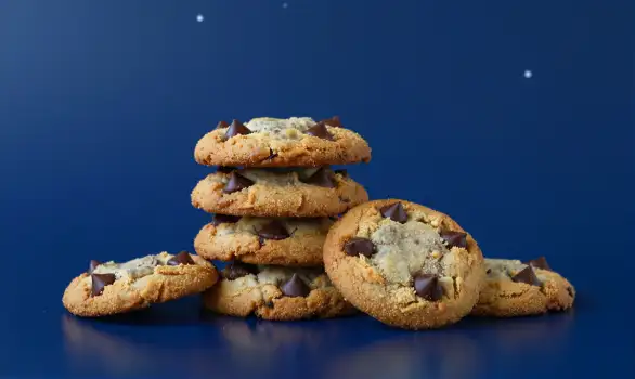 Stack of Golden Brown Chocolate Chip Cookies on Blue Background