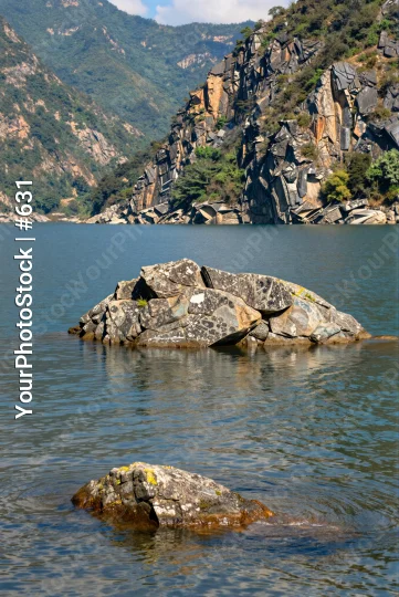 Serene Rock Formation in Calm Water mountains