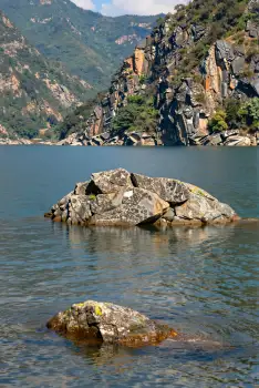 Serene Rock Formation in Calm Water mountains