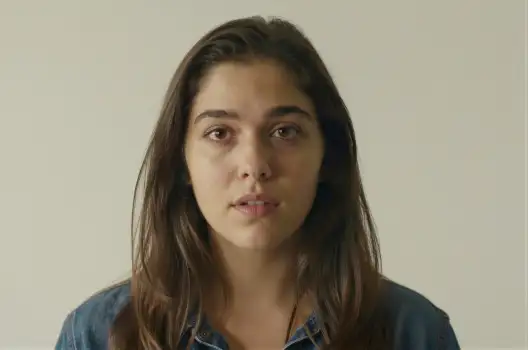 Young Woman in Serious Expression Wearing Blue Denim Shirt