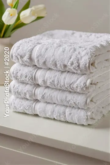 Neatly Folded White Towels on Dresser neatly stacked hotel