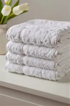 Neatly Folded White Towels on Dresser neatly stacked hotel
