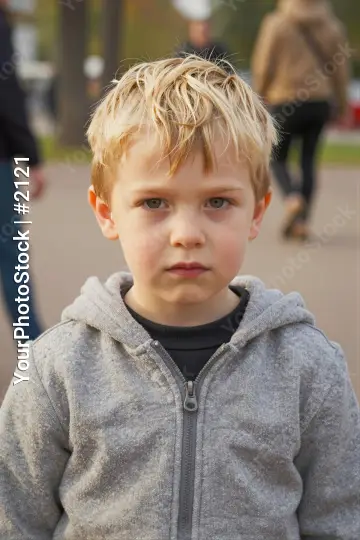 Young Boy in Serious Expression Wearing Hoodie kid