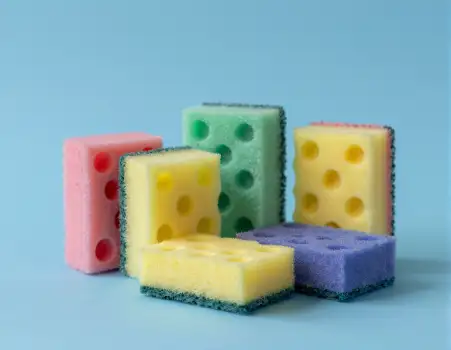Five Colored Sponges on Light Blue Background