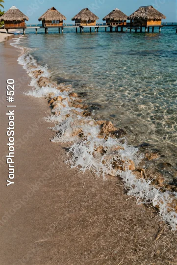 Serene Beach with Clear Water and Wooden Pier
