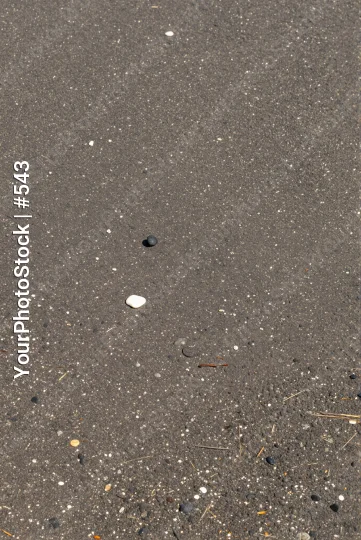 Close-up of Wet Asphalt with Speckles and Small Hole