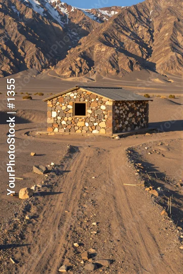 Desert Cabin in Snow-Capped Mountains landscape