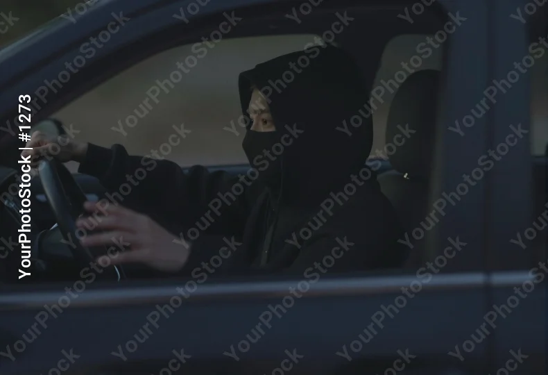 Person in Black Balaclava Driving Car driver steering wheel