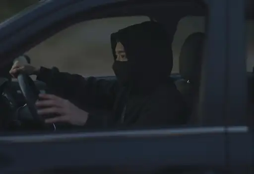 Person in Black Balaclava Driving Car driver steering wheel