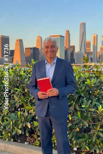Elderly Man Holding Book in Front of City Skyline