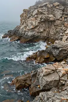 Rocky Coastline with Waves crashing waves overcast sky